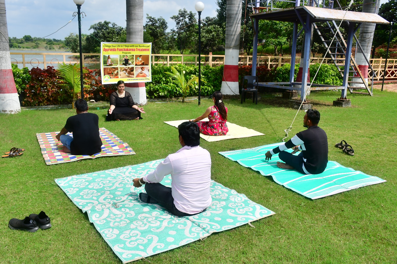 Guests practicing yoga by the lake